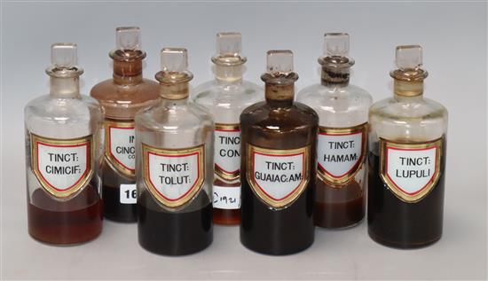 A collection of seven late Victorian chemists liquid drug jars and stopper, with gilt framed named labels, height 19cm